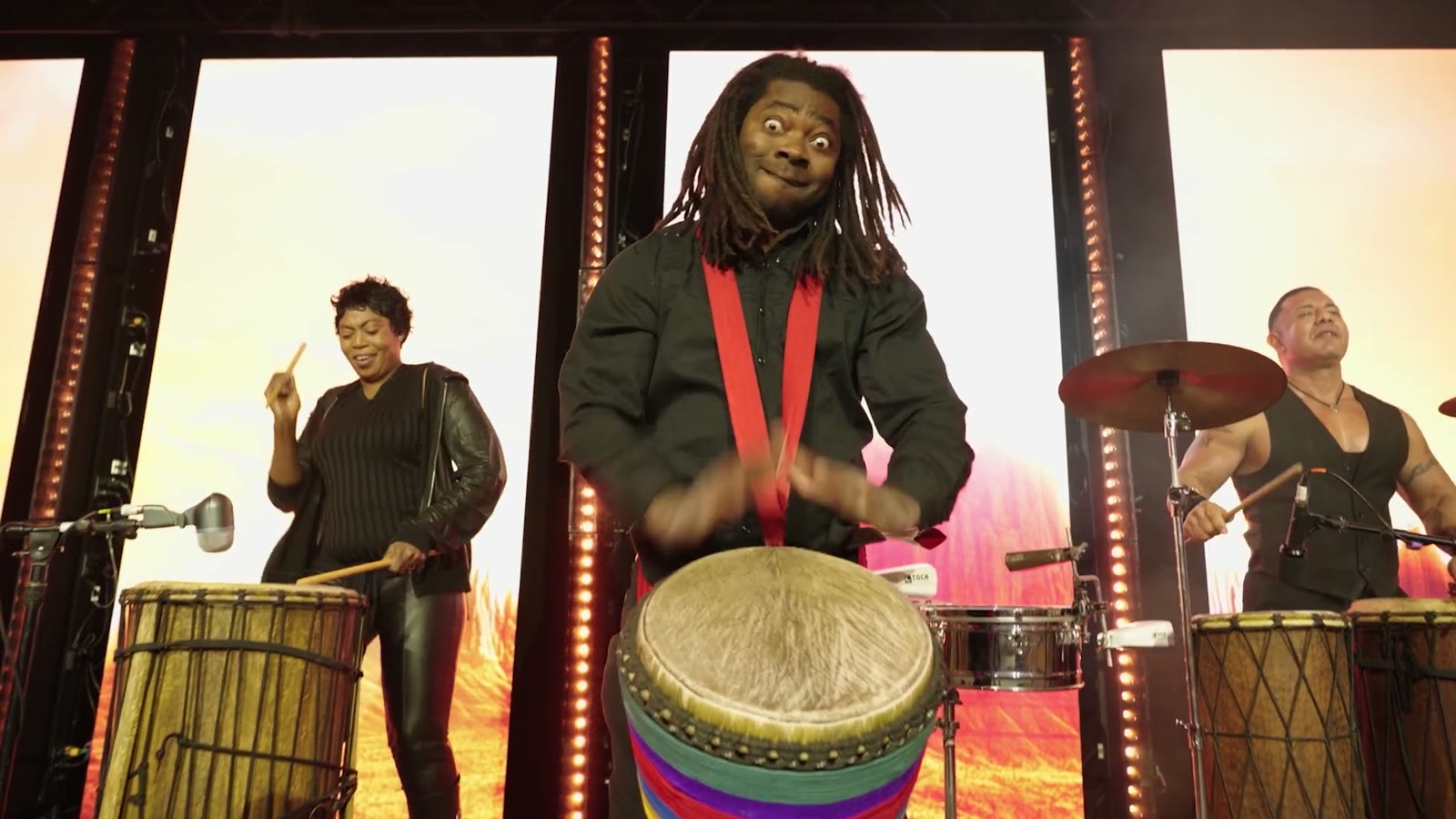 [CONFIRM] Percussion performance on a lit event stage.