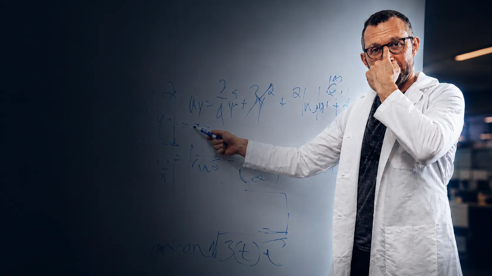 Healthcare scientist reviewing formulas on a whiteboard